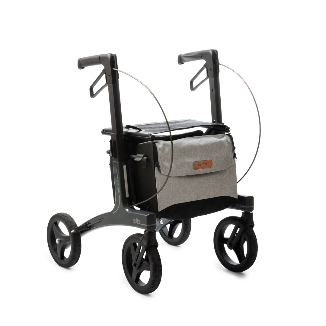 The Rollz Air Lightweight Folding Carbon Rollator weighs just 10.4 lbs, featuring a modern gray frame, four black wheels, upright handles, and a beige storage bag—delivering sleek and stable mobility assistance in a lightweight design.